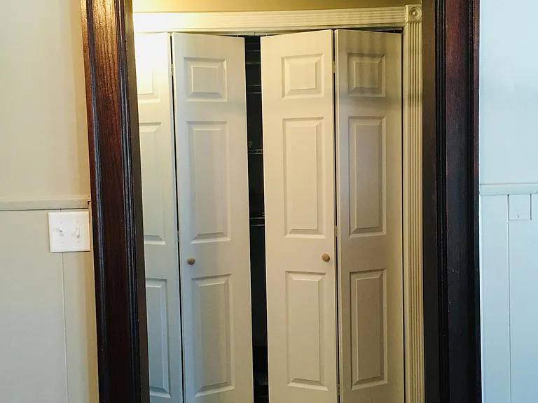 Entryway/mudroom with storage and shelving.
