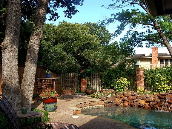Waterfall cascades into the sparkling pool 