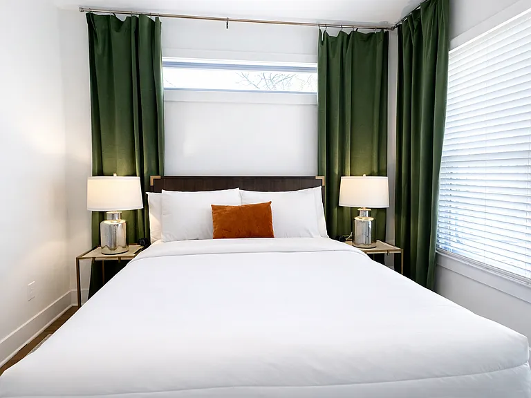 Located on the main floor, the Krog Suite is a relaxing queen room with hotel-level comfort. Enjoy plush linens, Smart TV, ceiling fan, bedside tables with charging ports, dresser, blackout curtains, and stylish designer decor.