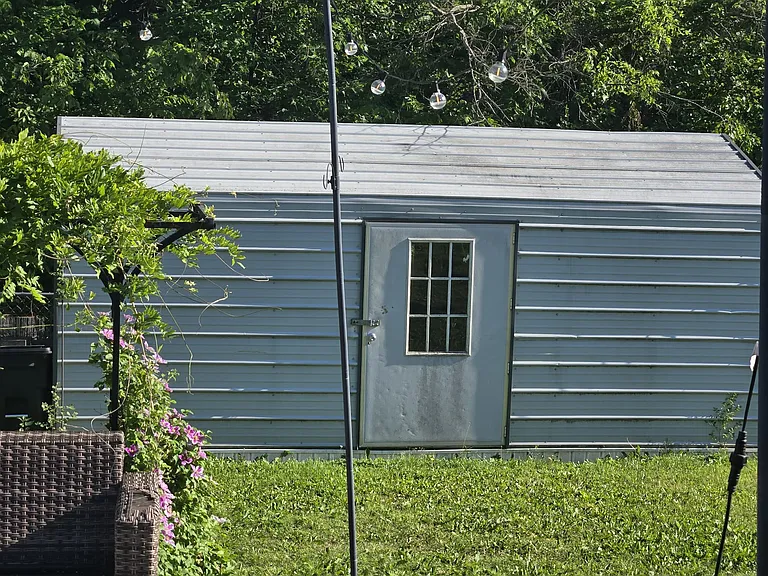 Storage shed with electric. Lots of shelving and a large work bench