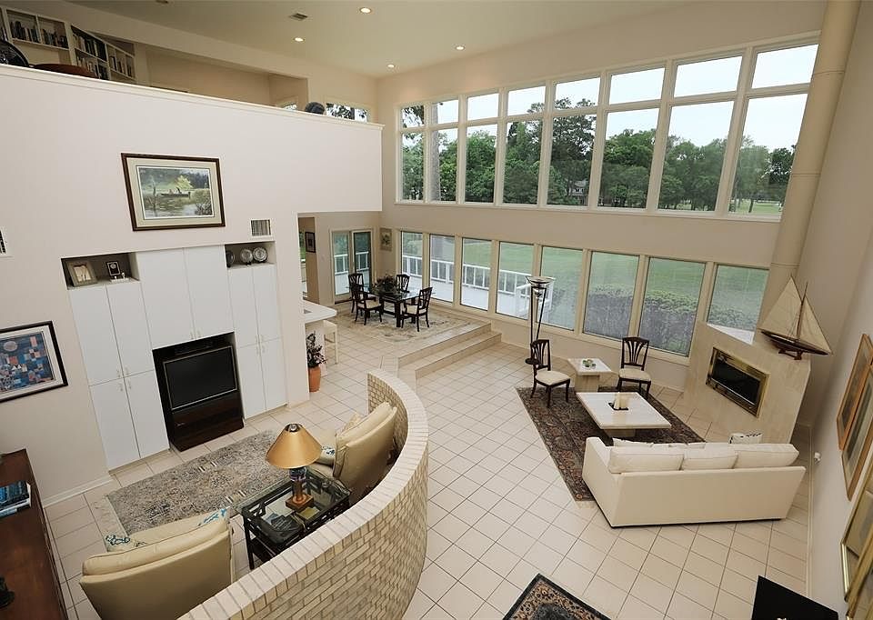 Stunning 2-story views of the 9th, 10th, 11th, and 18th fairways welcomes you as you enter this contemporary designed home on Walden Golf Course on Lake Conroe.