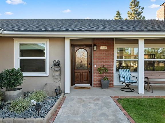Spacious gated front yard with a welcoming porch