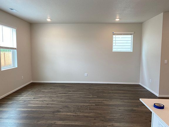 Big wide hall with windows to the backyard with green space
