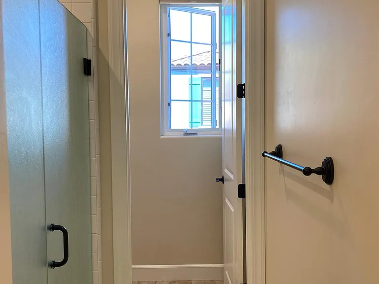 Spacious primary bathroom with oversized walk-in shower and private water closet.