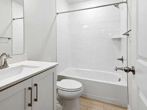 Hall Bathroom with Quartz Countertops in the Whitehall at The Village of College Park by DRB Homes.