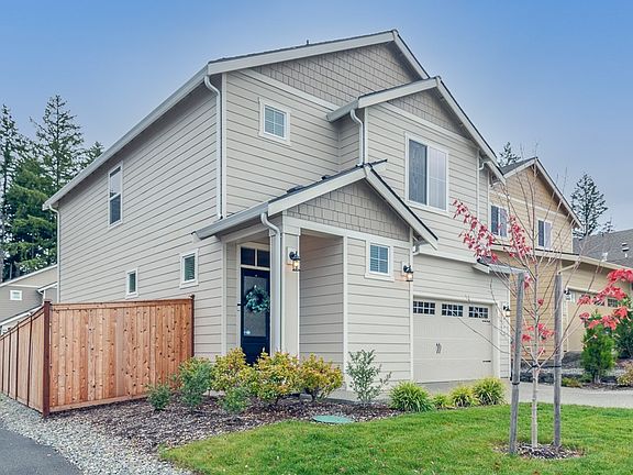 Front photo with view of fenced side yard.
