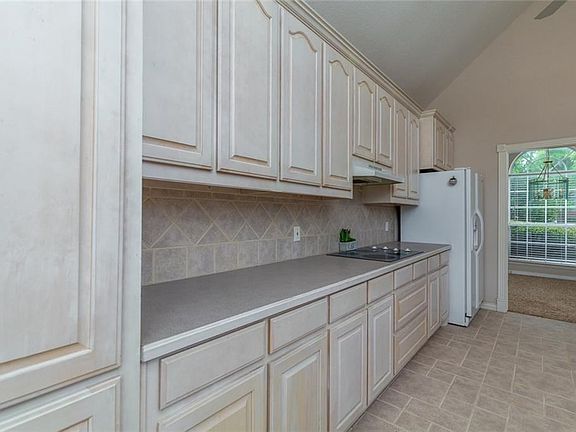 Comfortable kitchen for cooking, lots of cabinets for storage.