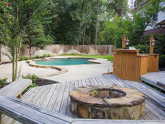 Flagstone firepit matches pool accents