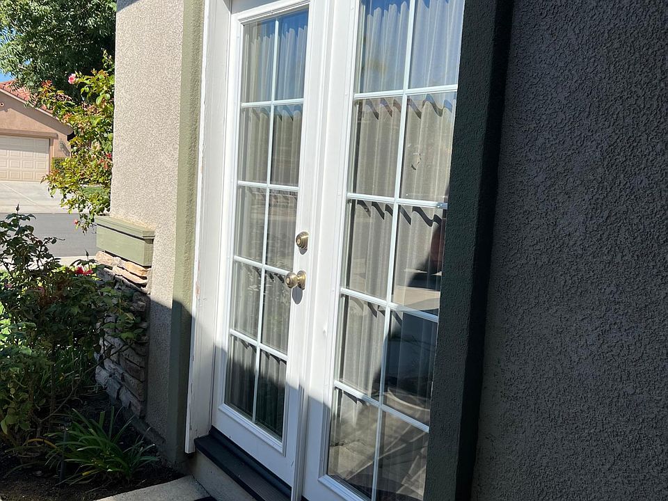 French door entrance with deadbolt. Motion light above door