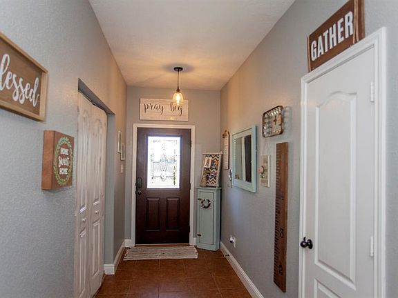 Tile flooring, industrial fixtures and natural light create a welcoming entry...