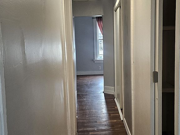 Hallway to living room with closet space. New recessed lights