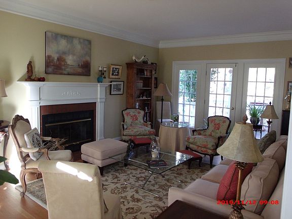 Fireplace in living room
						:
						with hardwood floors.