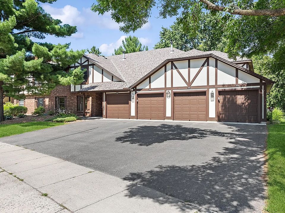 Tudor-style exterior. Attached garage + driveway space