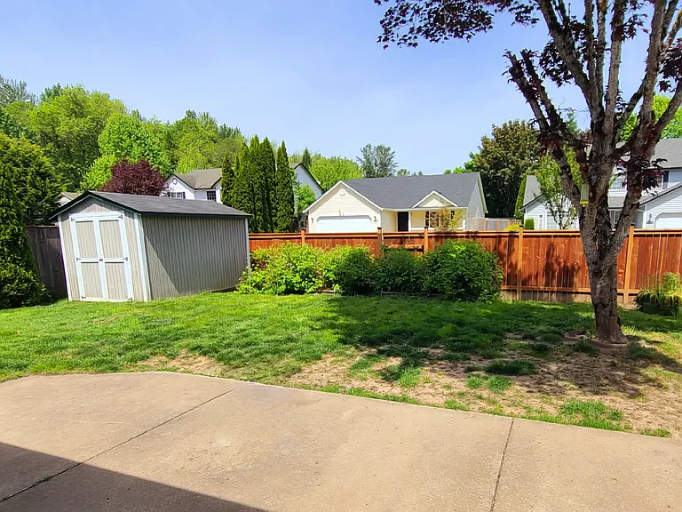 Backyard, fully fenced, with patio and shed
