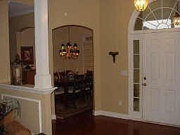 Soaring entry foyer complete with columns, palladian windows, and hardwoods!