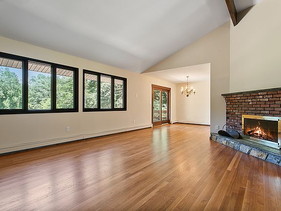 Vaulted Living Room with windows overlooking backyard and pond.