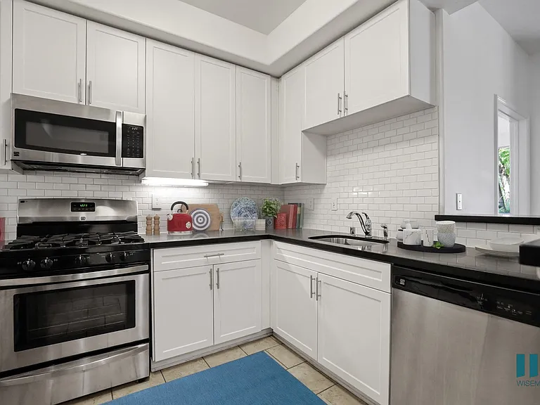 Kitchen with Stainless-Steel Dishwasher, Stove, and Microwave Oven