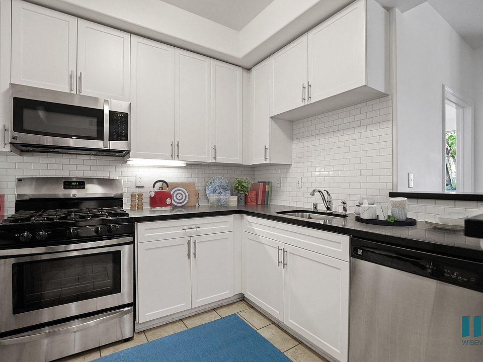Kitchen with Stainless-Steel Dishwasher, Stove, and Microwave Oven