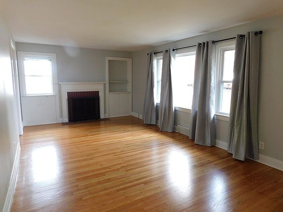 Large living room w/picture window and brick fireplace. Newly refinished hardwood floors.