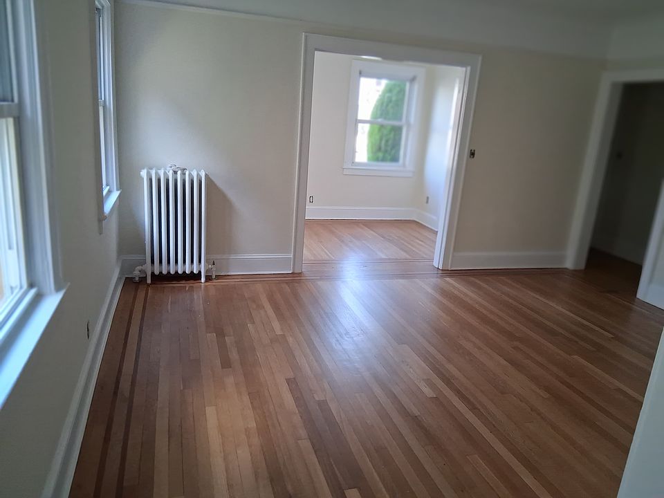 Living room into front den, front hallway with coat closet on right side