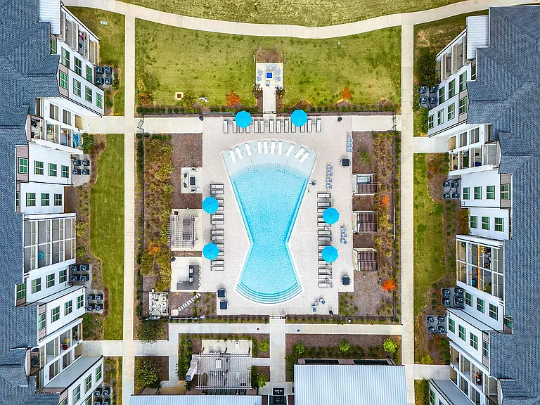 Experience the luxury of our modern apartments with an inviting pool and lush gardens.