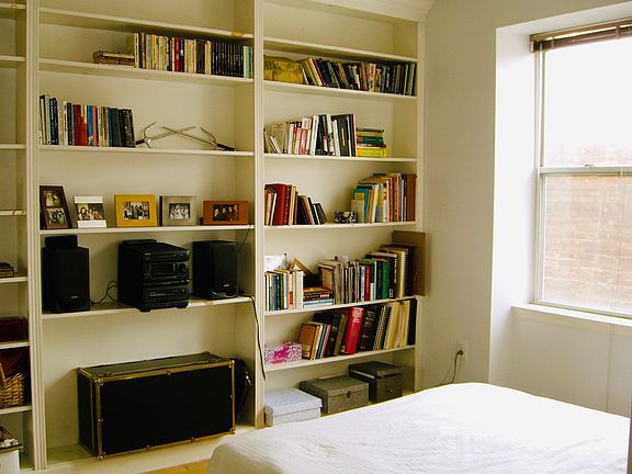 Bedroom, with built-in bookshelves
