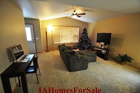 Living Room with vaulted ceilings and ceiling fan