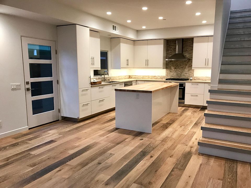 Kitchen with microwave, gas cooktop, oven, stainless fridge
