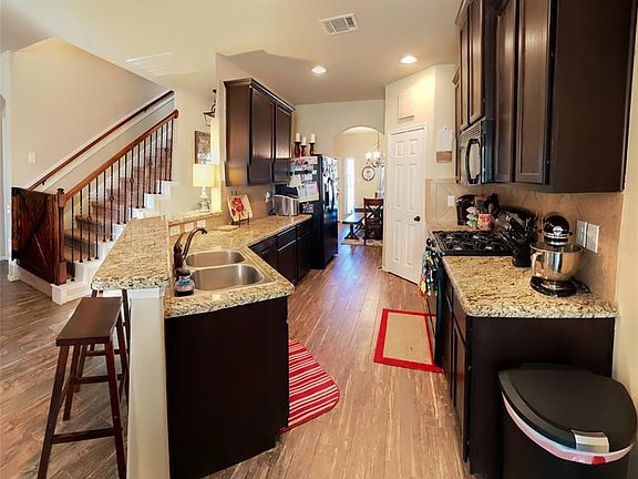 Beautiful granite countertops and cabinets with large pantry.