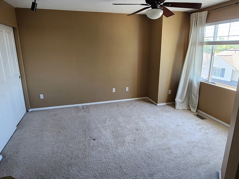 primary bedroom with 2 large closets and linen closet. sunset views of the olympic mountains.