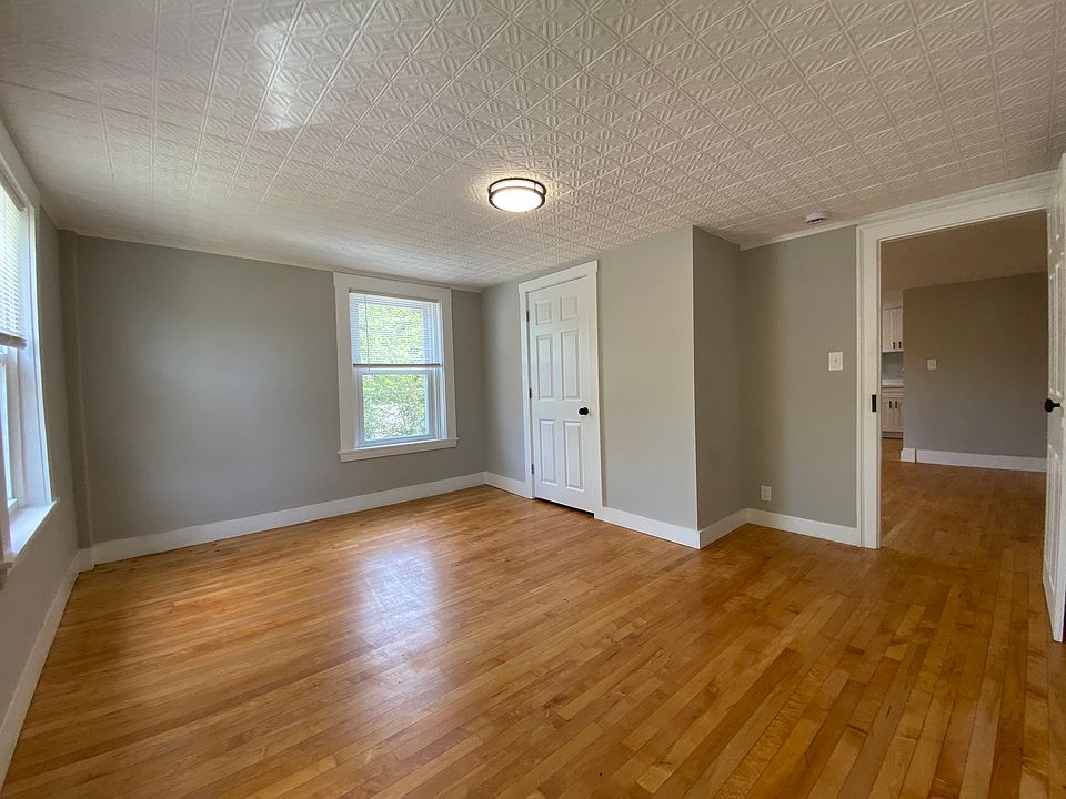 Bedroom with closet and doorway to living room.