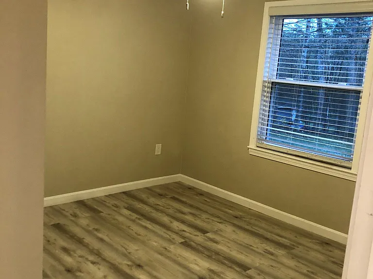 Small Bedroom office with mini-split for heating/cooling, a large window and a ceiling fan