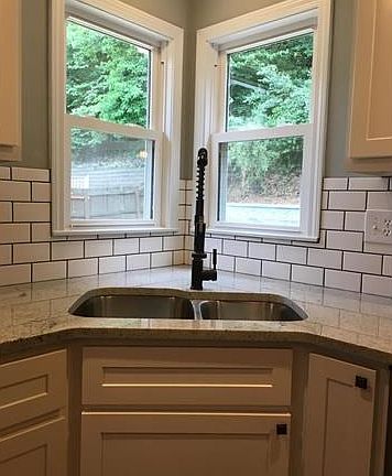 Extra deep double bowl sink, granite counter tops.  Double windows over sink.