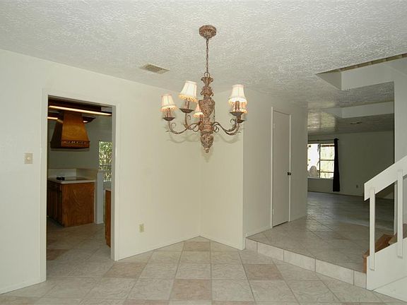 VIEW FROM DINING ROOM TO ENTRY AND KITCHEN