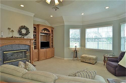   Another view of the den with the gas log fire place and built ins.