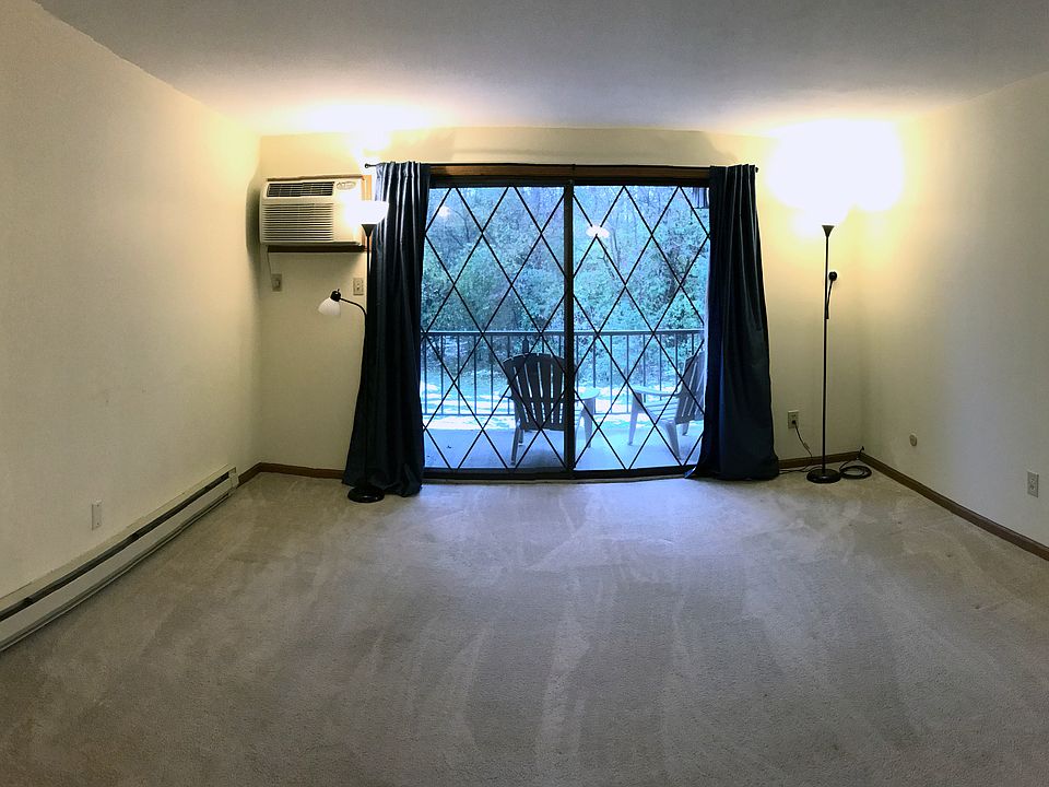 Large living room overlooks a wooded courtyard