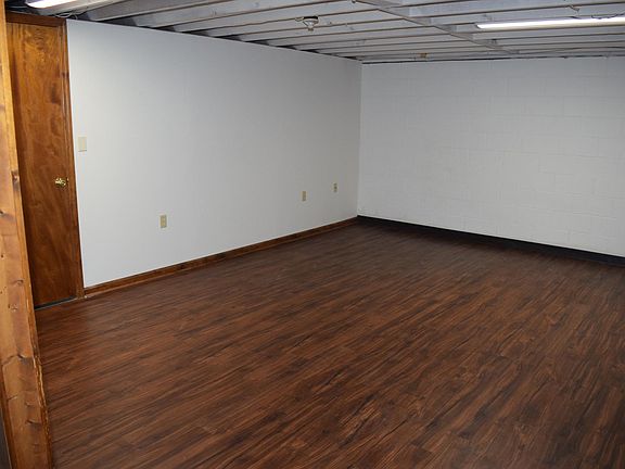 This room in the basement can be used for a TV room, play room for children, or a home office. The door leads to the laundry hook up and large storage area.
