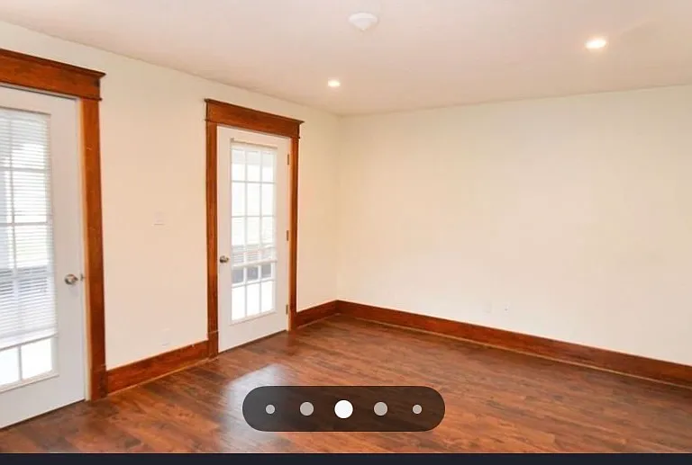 living room facing door entering onto porch.