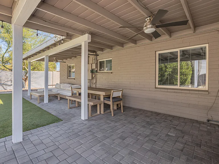 Large covered patio with ceiling fans, West Elm outdoor furnishings, dining area, and lounge seating for relaxed outdoor living and intimate entertaining