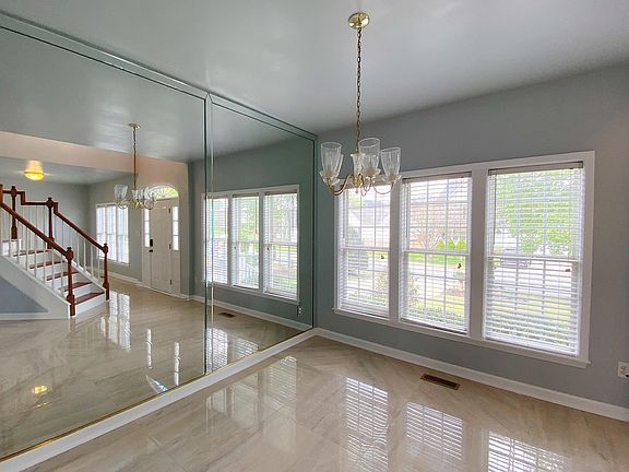 Dining Room with whole wall mirror