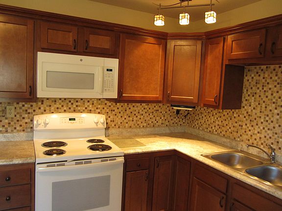 Eat in kitchen with electric stove, microwave, refrigerator, and dishwasher.