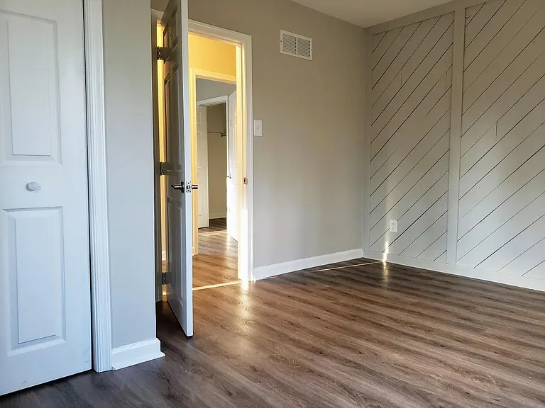 Bedroom #1 with unique accent wall and LARGE closet for storage!