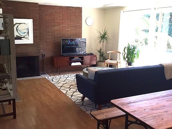 living room & dining area with MCM brick & working fireplace