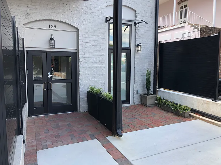 Apartment One is the door on the right side. The main entrance to all payments in the larger door on the left.