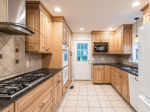 Kitchen with large gas stove, new dishwasher, granite counters, double oven.