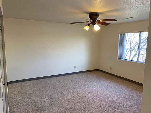 Living room from bedroom hallway. Ceiling fans in many rooms.