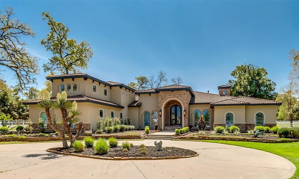Exquisite Mediterranean Villa situated on almost 4 acres in the gated enclave of Crown Oaks.