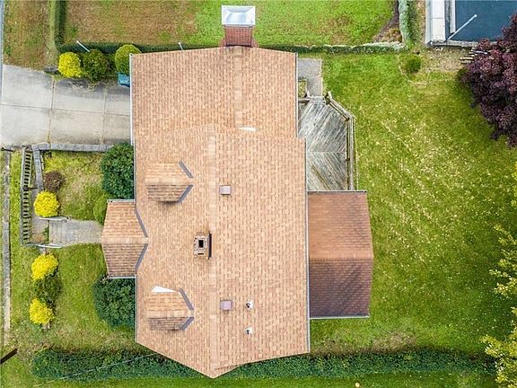 Notice the new roof and the lovely level yard in back.