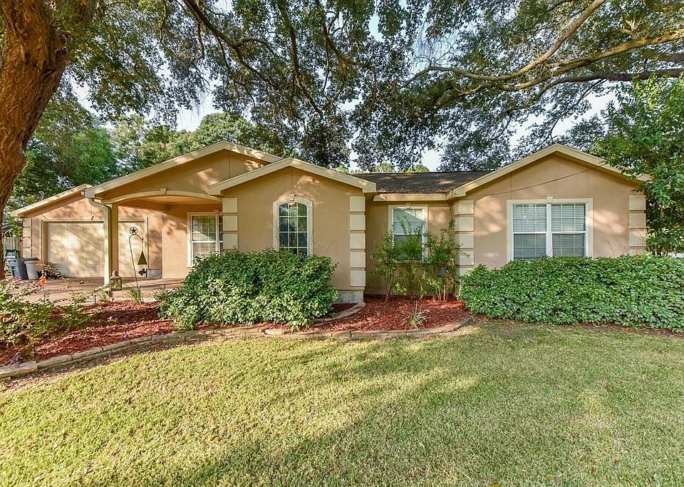 Inviting entry with mature shade trees welcomes you home.
