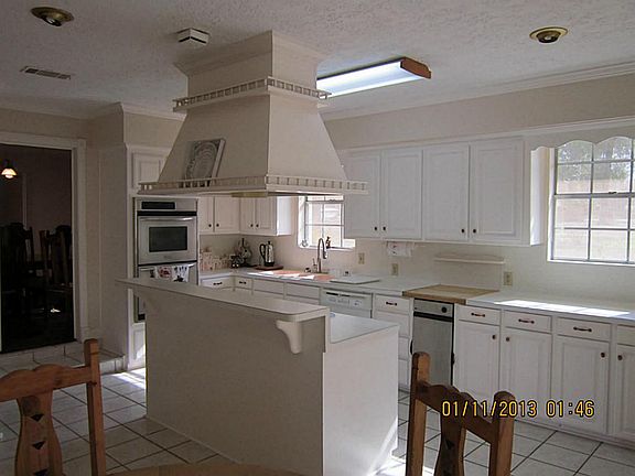 White counter tops, white cabinets very lighted
